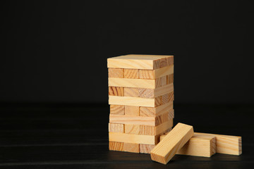 Blocks of wood on black background. Tower