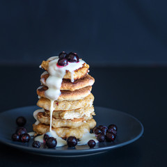 Oatmeal pancakes with berries and sweet sauce,