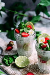 Mojito cocktail with strawberries, mint and lime. Lemonade