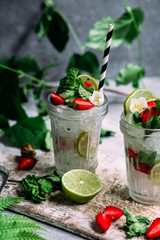 Mojito cocktail with strawberries, mint and lime. Lemonade