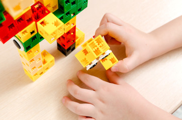 A child plays with colorful construction blocks