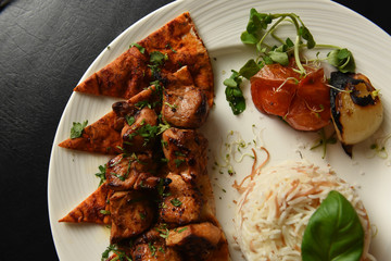 Kebabs served with vegetables and rice