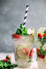 Mojito cocktail with strawberries, mint and lime. Lemonade