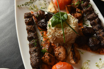 Kebabs served with vegetables and rice