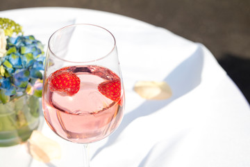 Detail of sparkling wine with strawberries served during a party