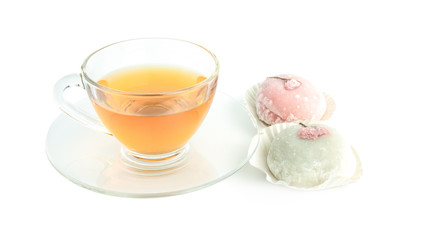 Tea cup transperent glass and snack japanese name Daifuku Mochi pink cherry blossoms,isolated on white background.