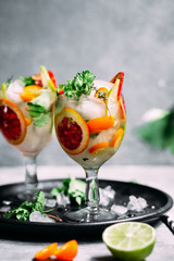 Lemonade with orange, lime, kumquat and mint in a glass