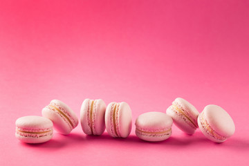 Obraz premium Rose macaroons on pink background