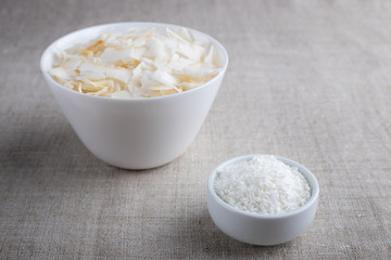 Coconut chips and shavings in a bowl on a cloth tablecloth