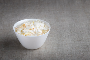 Coconut chips in a bowl on the table