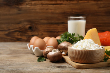Fresh products rich in vitamin D on wooden table