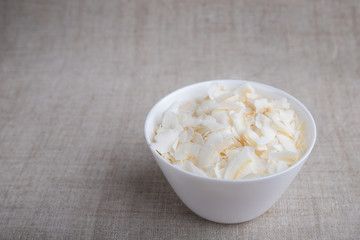 Coconut chips in a bowl on the table
