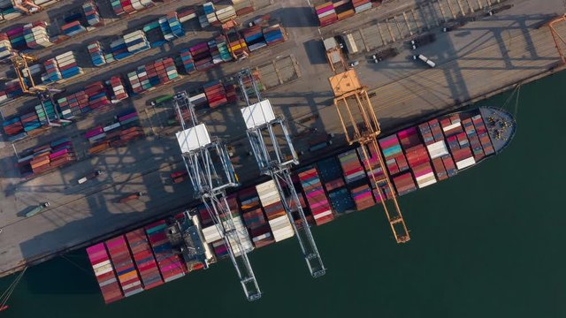 Time lapse Container , container ship in export and import business and logistics. Shipping cargo to harbor by crane. Water transport International. Aerial view and top view.