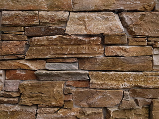 A close up view of slate stone wall. A detail of a fence. Background texture. Horizontal view.