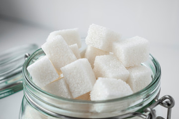 Refined sugar in a glass jar close-up