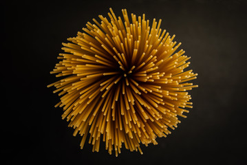 bunch of spaghetti close up on black background