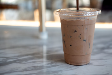 Cold Mocha coffee in plastic cup at cafe.