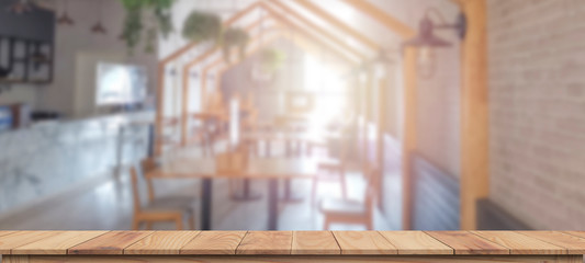 Empty wooden table  and blurred store can be used for display or montage your products..