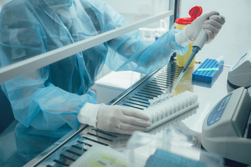 Professional scientist working with liquids in sterile conditions