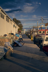 Naklejka premium fishing boat moored and lined up with some nets