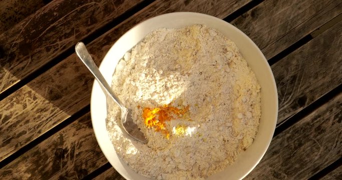Whisking cake mix in a silver bowl