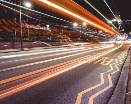 NEWTON, SINGAPORE - DECEMBER 2019: A LONG EXPOSURE of a public bus zooming past on the road in Singapore at night