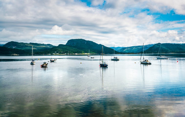 View on a lake in Plockton village in Highlands, Scotland with boats on it
