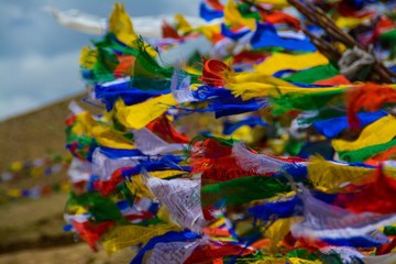 Fototapeta na wymiar Close-up Of Multi Colored Prayer Flags Against Blue Sky