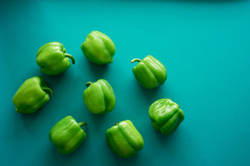 Bulgarian peppers are green on a green background. Fresh and crunchy. Vegetarian food.