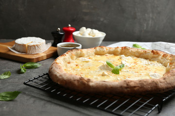 Delicious hot cheese pizza on grey table