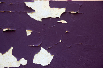 wall with peeling stucco with flakes of paint