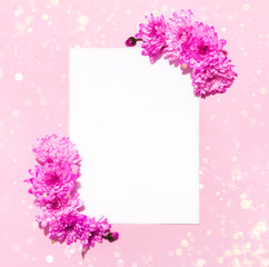 White vertical paper mockup with purple flowers on pink with copy space. Floral stationery greeting design template