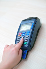 Girl pays purchase through the terminal pos