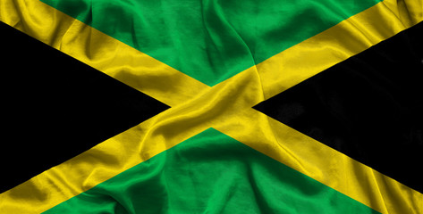 National flag of Jamaica background with fabric texture. Flag of Jamaica in correct proportions waving in the wind. 3D illustration