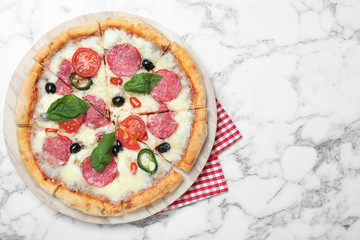 Delicious pizza Diablo on white marble background, top view. Space for text