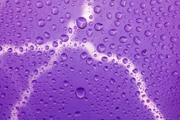 Lightning bolt on the background of raindrops on the glass