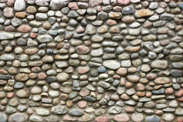 stone wall for the fence of the house from large boulders rubble