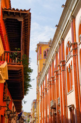 Walking the narrow and colorful streets with historic old buildings with wooden balconies and urban...
