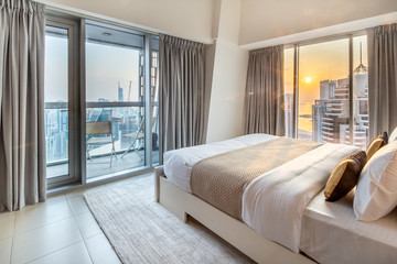 Elegant Bedroom of a High Rise Apartment Overlooking Marina During Sunset © laphotography