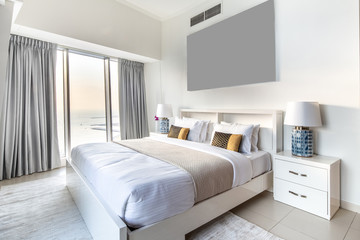 Elegant Bedroom of a High Rise Apartment Overlooking Marina During Sunset
