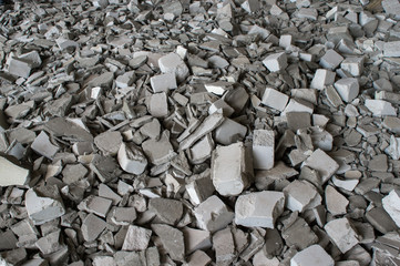 Gray fragments of silicate bricks with the remains of the solution after the demolition of the building wall. Background