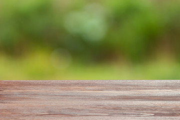 Empty wooden table on blurred nature background