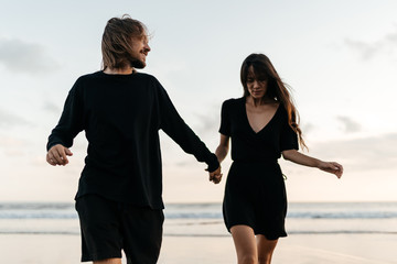 Fototapeta premium Young couple in love, Attractive man and woman enjoying romantic evening on sunset