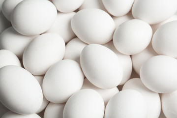 Fresh raw white chicken eggs as background, above view