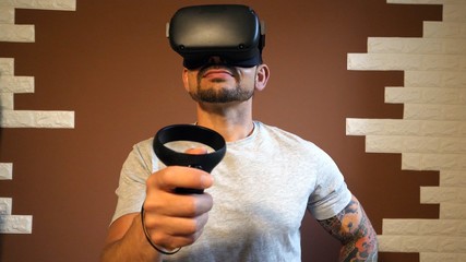 35 years old man home playing a virtual game with 3d glasses