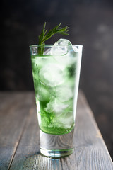 Sweet tequila based green cocktail with tarragon and rosemary. Selective focus. Shallow depth of field.
