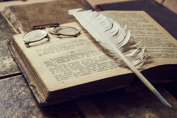 old book with feather and ink