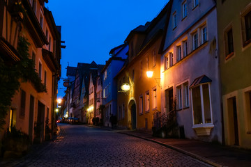 Fototapeta na wymiar Night view to narrow medieval street in old town Rothenburg ob der Tauber, Bavaria, Germany. November 2014