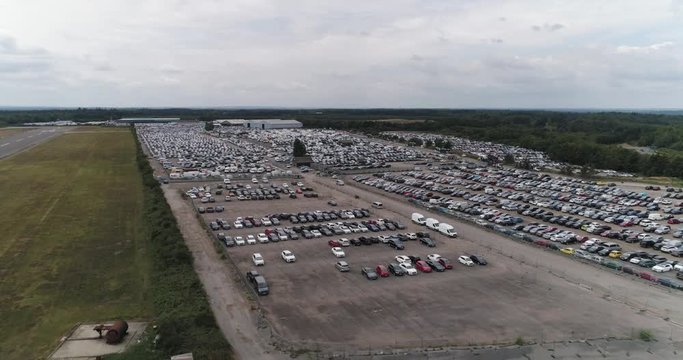 Large car auction car park on industrial estate. Lots of cars of various sizes and colours