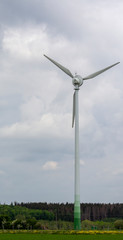 single wind turbine on a piece of meadow